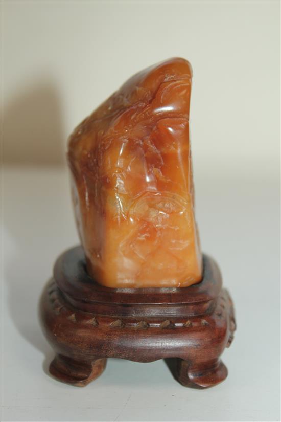 A Chinese Tianhuang stone landscape carving, 136g., 7 x 4 x 3.5cm, wood stand